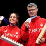 Silver medalists Şevval İlayda Tarhan and Yusuf Dikeç of Turkey on the podium during after the 10-meter air pistol mixed team medal ceremony