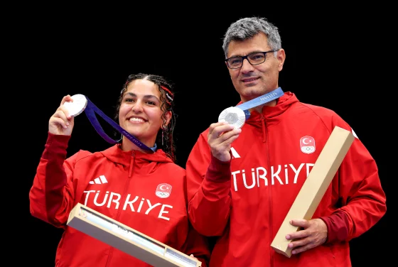 Silver medalists Şevval İlayda Tarhan and Yusuf Dikeç of Turkey on the podium during after the 10-meter air pistol mixed team medal ceremony